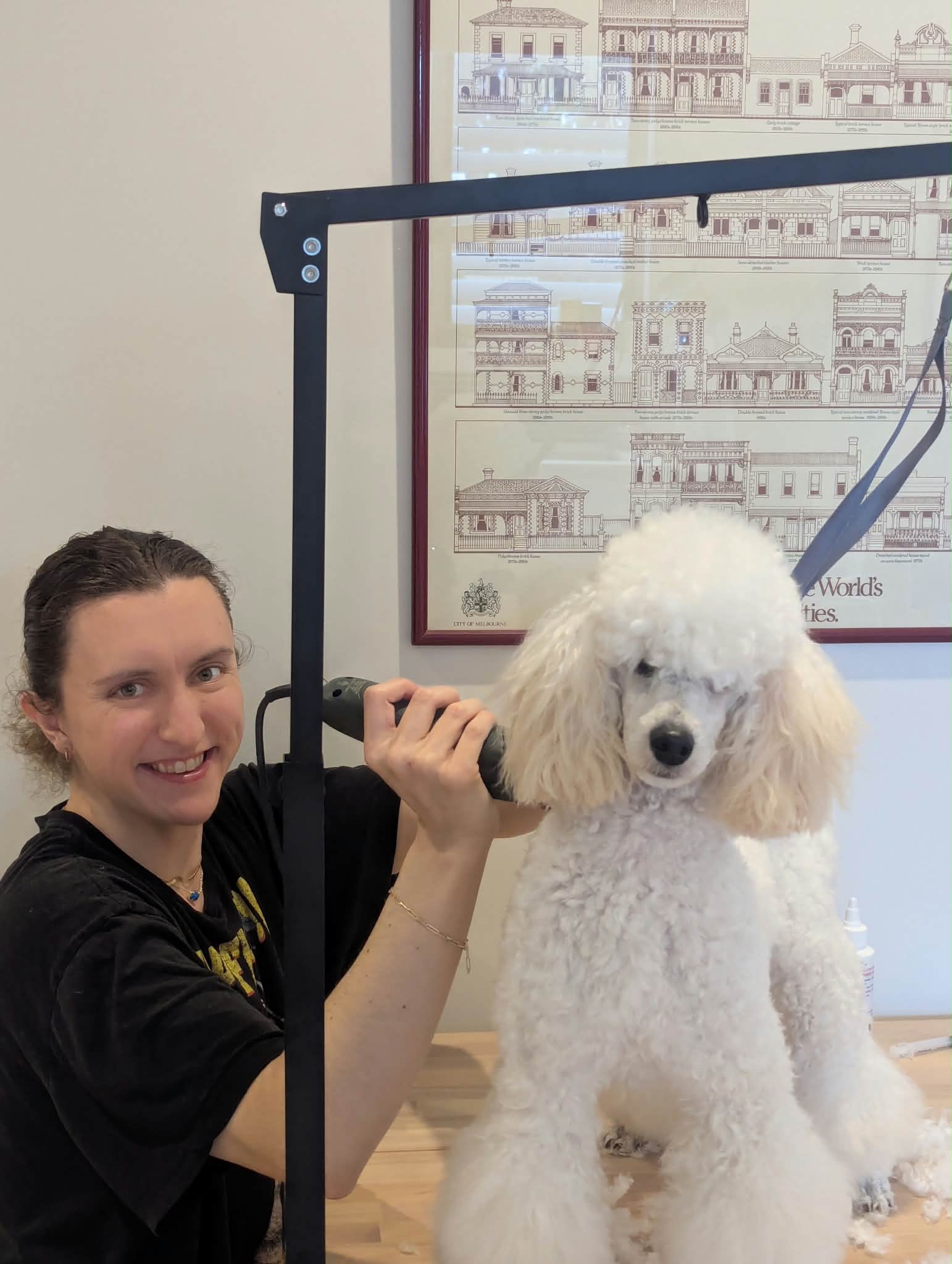 Abby smiling beside Duchess with grooming clippers in hand